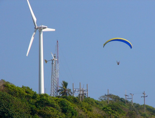 hang glider near wind generators in Nai Harn Bay